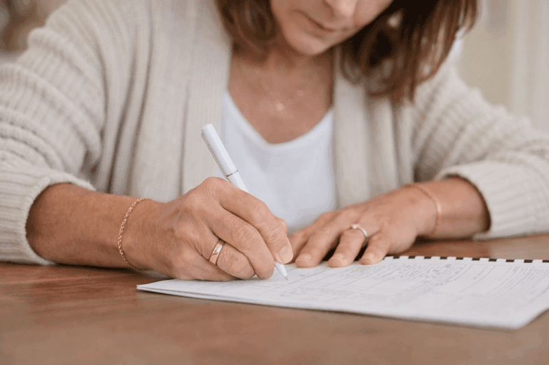 Woman hand-writing at table