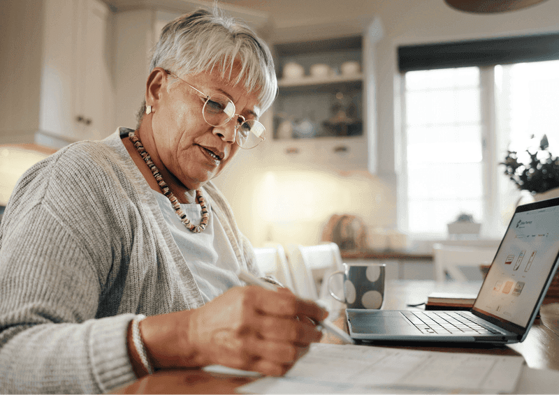 Woman writing computer kitchen
